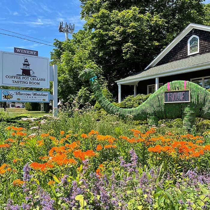 Flower beds and the tasting room sign at Coffee Pot Cellars in Cutchogue