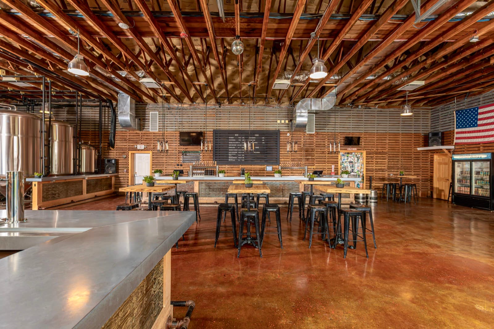 High tables and brew tanks in the taproom at Jamesport Farm Brewery