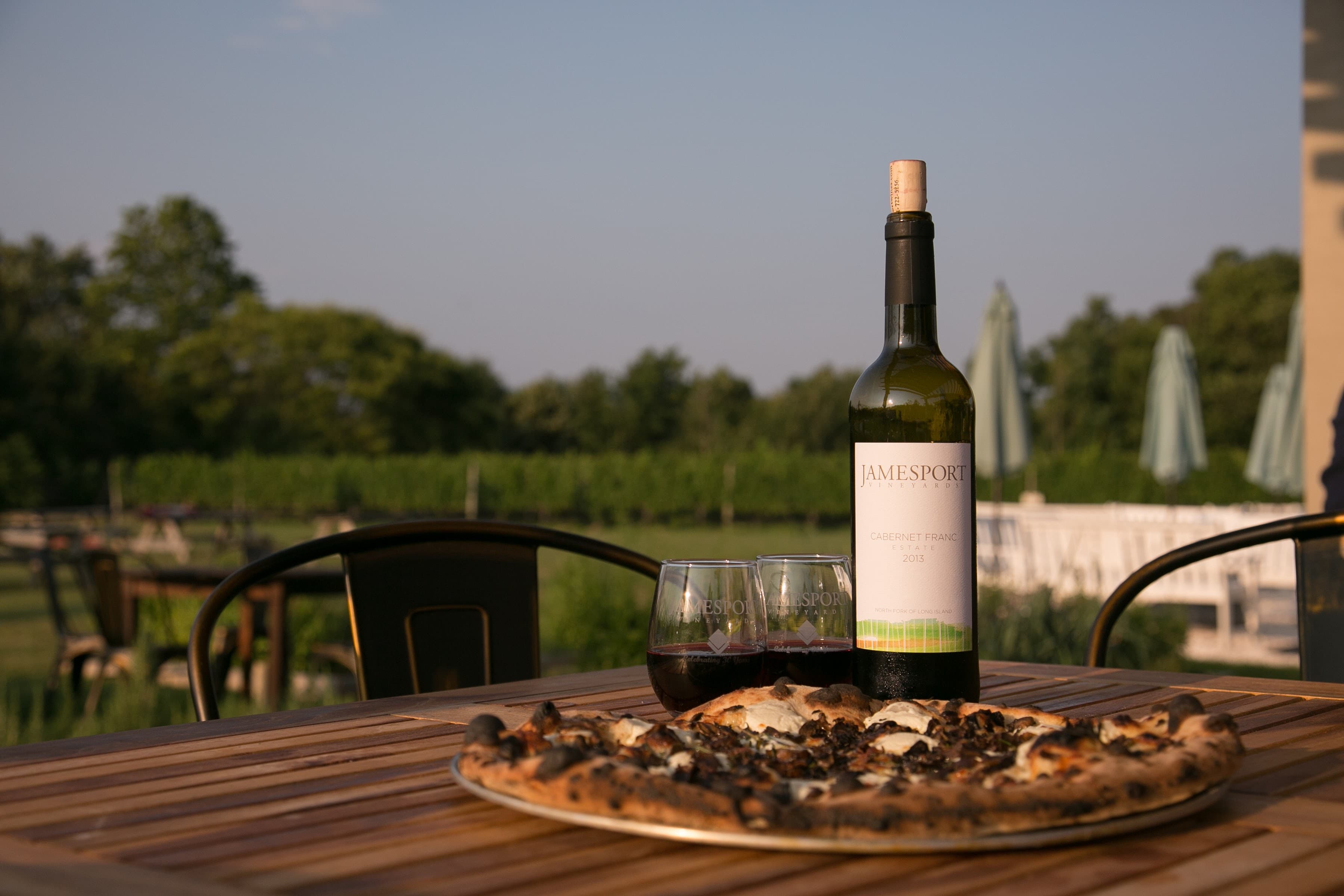 Wood-fired pizza and a bottle of Cabernet Franc on the terrace at Jamesport Vineyards
